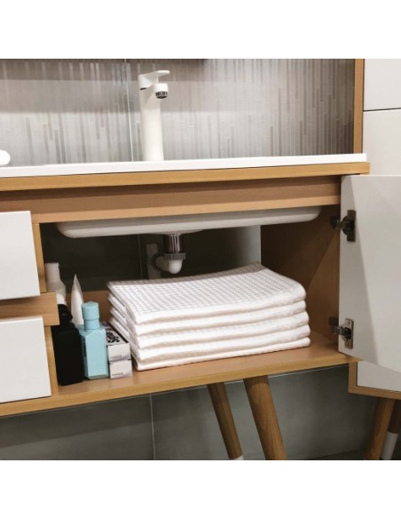 Space saving connecting pipe inside bathroom furniture for more storage space.